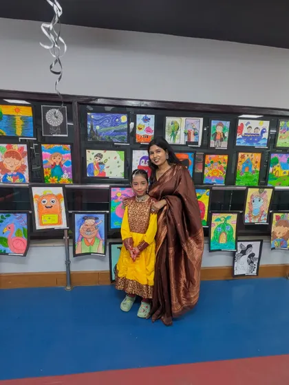 A proud moment between a student and her mentor in front of a wall of vibrant artwork. This photo embodies the Guru-Shishya bond we cherish, celebrating the journey of learning and creativity together.