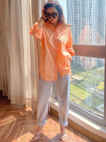 Here’s how to dress up your denim. I paired these light-wash jeans with a silky peach button-down shirt and delicate heels for a smart-casual look perfect for a brunch or daytime event.