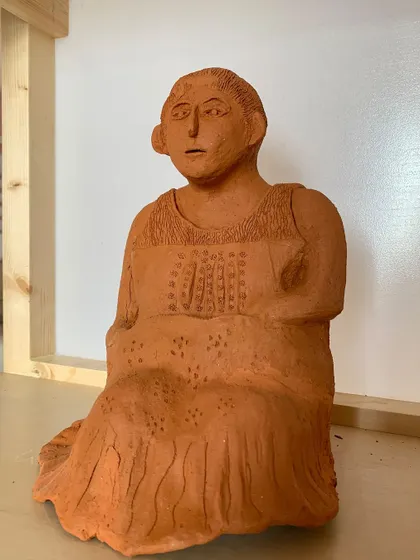 The seated woman sculpture, seen from a different angle in my studio. The raw terracotta has a warmth and earthiness that I absolutely love.