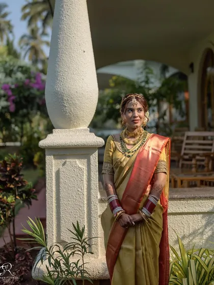 A full-length portrait of the bride in her gorgeous South Indian wedding saree.