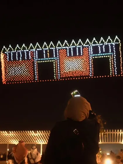 A formation depicting traditional Kuwaiti architecture, captured by an enthralled audience. We design our shows to resonate with local heritage and create lasting memories.