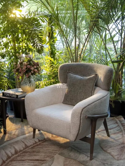 We design furniture that feels connected to its environment. The Verdelle Armchair, crafted in solid ash wood and soft boucle fabric, is a perfect example. Its sculptural form and tactile warmth are a subtle nod to mid-century elegance, designed to create a sanctuary of style.