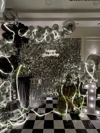 A different angle of the disco party setup, highlighting the layered details like the LED light strips woven through the balloons and the reflective disco balls that catch the light.