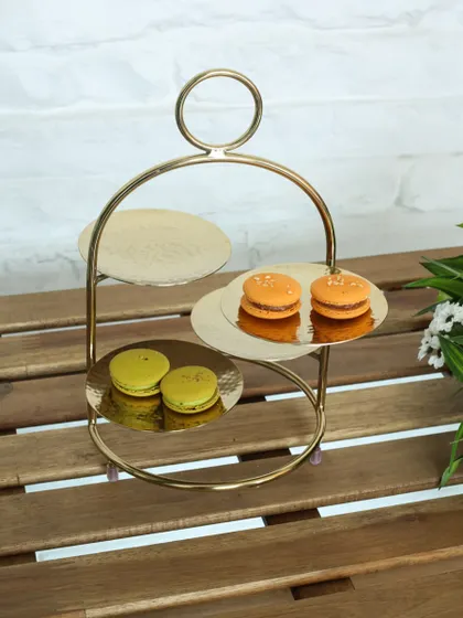 The modern Tête-à-tête stand with three hammered gold plates. Its unique, asymmetrical design is perfect for adding a contemporary touch to your afternoon tea service.