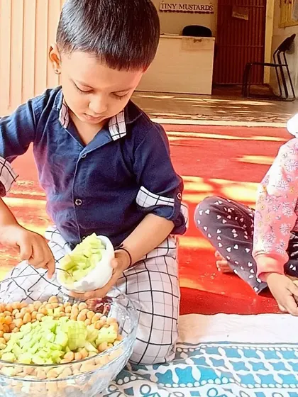 Making a healthy and delicious chickpea salad, where children practiced chopping vegetables and mixing ingredients to create a nutritious meal.