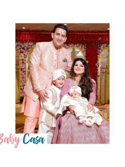The full family, looking picture perfect in their coordinated outfits. It's always special to see my creations become part of such happy family moments.