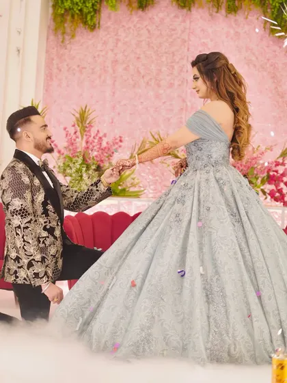 A magical moment captured as the groom proposes to his bride, who is wearing my ethereal light blue ball gown. The voluminous skirt creates a beautiful silhouette, perfect for romantic photos.