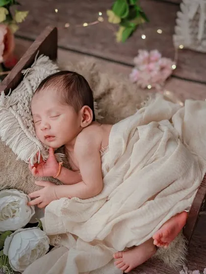 The tiniest miracles bring the greatest joy. This magical setup with a rustic bed, flowers, and fairy lights is one of my favorites.