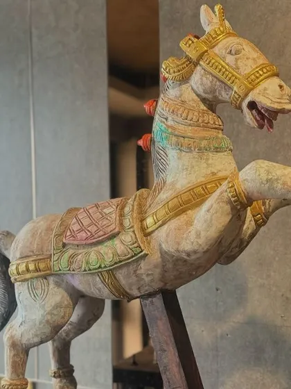 A vintage hand-painted wooden horse, a classic decorative piece from our Navaratri festival showcase. Such items bring a touch of rustic, palatial charm and celebrate the grace of Indian folk art.