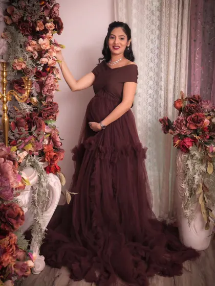 A stunning solo portrait in a rich burgundy gown. The off-shoulder design and flowing tulle create a look of pure elegance.