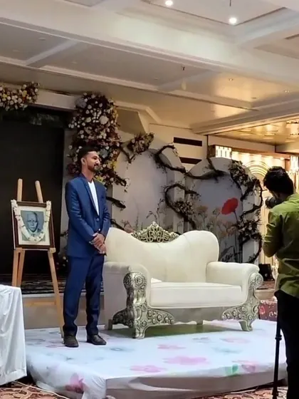 A moment on stage after the performance in Amravati, with the final sand portrait gifted to the family on an easel.