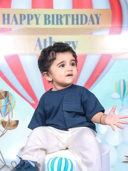 A charming 'Baby Boss' themed birthday party, with a sophisticated black and white color scheme, custom props, and a stylish backdrop, perfect for a little executive.