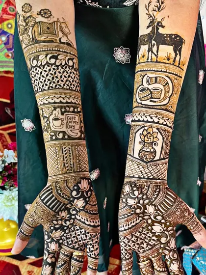 A truly personalized design for a nature and coffee lover. This mehndi includes deer, a Cafe Coffee Day logo, and other custom elements that reflect the client's passions and story.