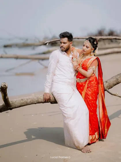 A stylish portrait of the couple on the beach, posing with driftwood for a rustic and natural feel.
