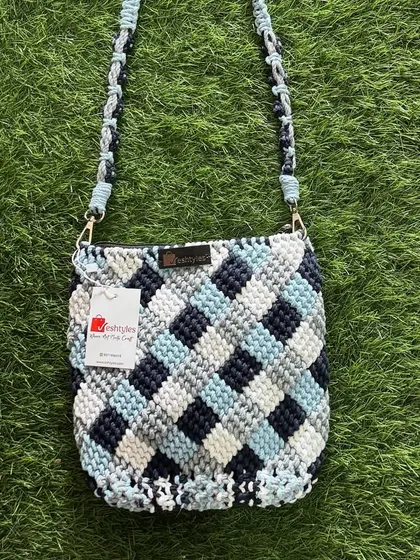 A full-length view of the blue checkered sling bag, perfect for seeing how it hangs.