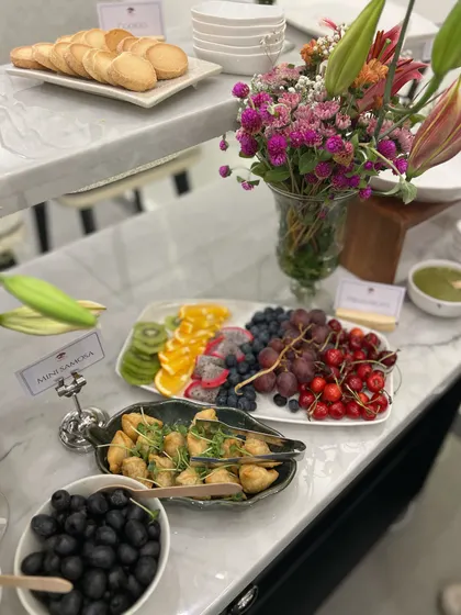 Another shot from the store opening, showcasing our fresh fruit platter and mini samosas. We aim to provide a balanced menu with both healthy and indulgent options.