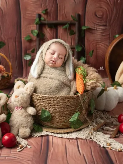 This wide shot shows the full woodland bunny theme, with baskets, pumpkins, and lots of greenery.