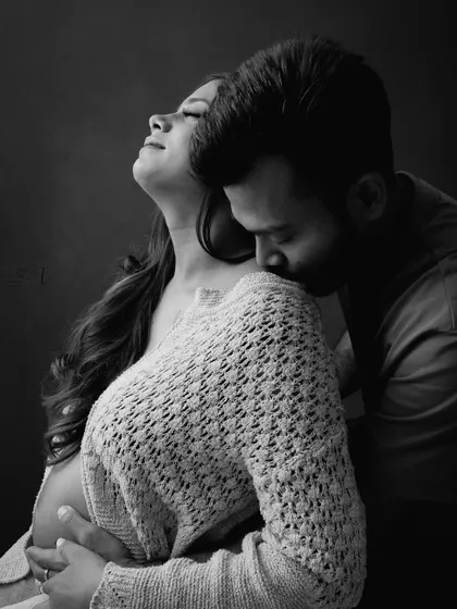 An intimate and passionate black and white portrait. This photo beautifully captures the deep connection and love between the expecting couple.