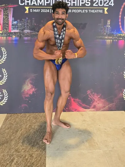 A full-body shot backstage, showing the overall conditioning required for a competition.