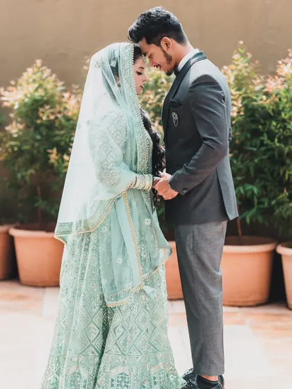 An intimate and serene portrait of a couple on their wedding day, holding hands and sharing a quiet moment together.