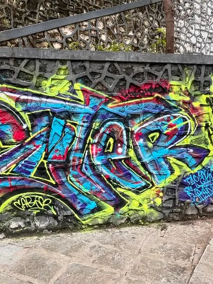 A colorful piece on a stone wall, showing how I adapt my lettering style to fit the texture and shape of the surface.