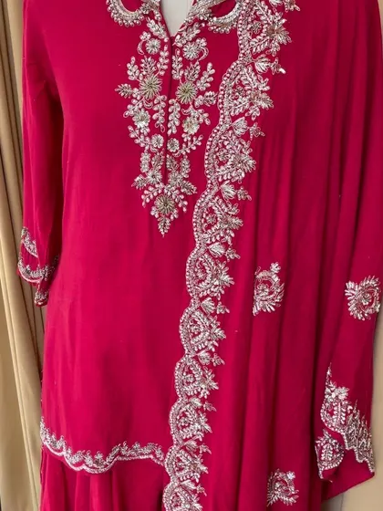 A close-up view of the detailed hand embroidery on the Moonga silk kurta and sharara set. This level of craftsmanship is what makes each outfit special.