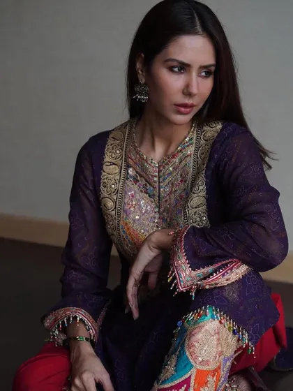 Another intimate portrait that showcases the rich textures and colors of the outfit. The styling is all about celebrating heritage and craftsmanship in a way that feels personal and elegant.