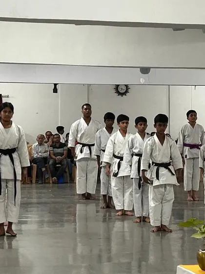 Senior students lead the line during the belt exam, setting an example of focus and strong posture for the junior belts behind them.