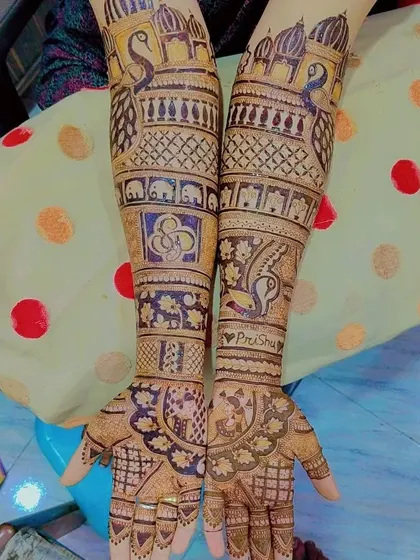The couple's hashtag 'PriShu' is woven into this intricate design, a modern way to personalize your wedding mehndi.