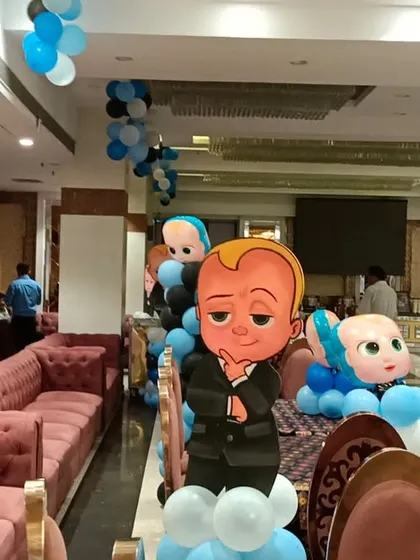 A Boss Baby character cutout on a balloon pillar, a great decorative element to place around the party venue.