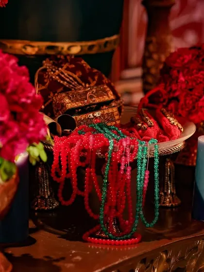 A detail shot of jewel-toned beads and a single candle, part of the intricate styling for the Mysore-themed event. Every small detail is curated to add to the story of opulence and heritage.