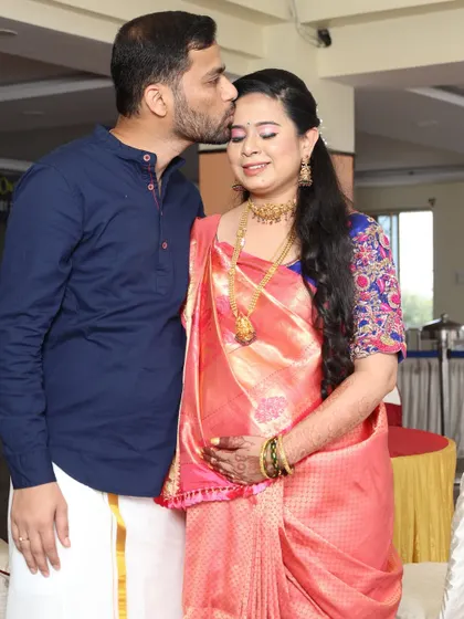 A sweet, candid moment. The makeup is subtle yet elegant, designed to photograph beautifully and last through all the happy moments of the baby shower.
