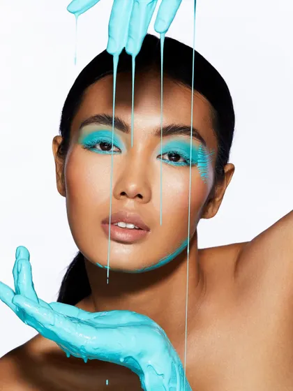 The dripping turquoise paint creates a stunning visual in this shot, showcasing the creative freedom we encourage in our students.