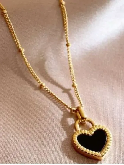 The black heart padlock necklace, a stylish and affordable piece at only 10 shekels. Its color is guaranteed, and it's perfect for adding a unique touch to your look.