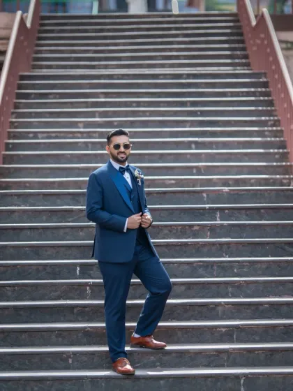 Using the leading lines of a grand staircase to create a powerful groom portrait. This shot is all about confidence and style.