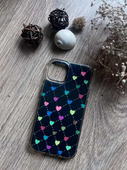 A cute pattern of colorful hearts on a black phone case insert.