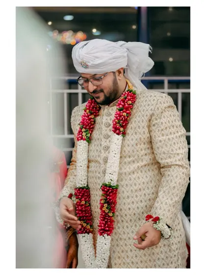 Another portrait of the groom, framed through an opening, creating a more candid and personal feel.