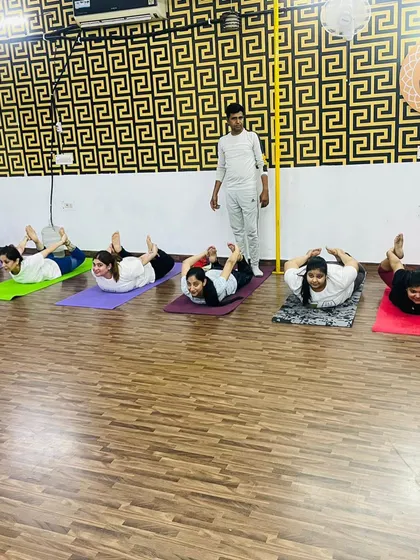 Our instructor observing the class during Bhujangasana, or Cobra Pose. We ensure everyone maintains the right posture to avoid injury and gain maximum benefit.
