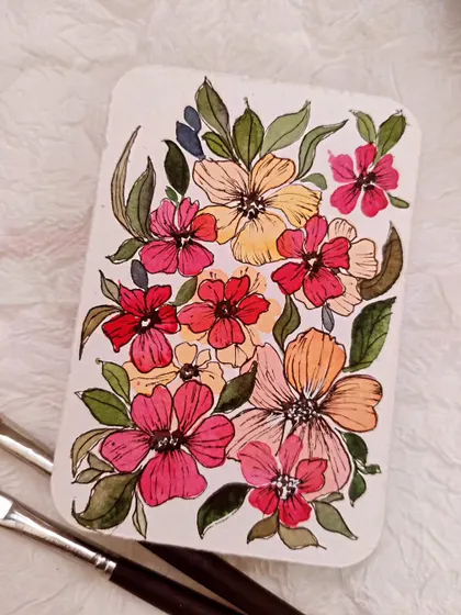 Here, I've outlined the watercolor flowers with ink to make them pop. This is a simple but effective technique for adding definition to your work.