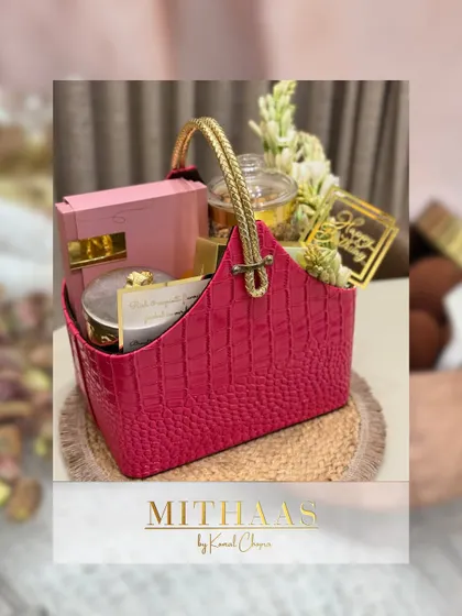 This vibrant pink basket was curated with a mix of treats and fresh tuberoses. It demonstrates how you can add personal touches like fresh flowers to make your hamper even more special.
