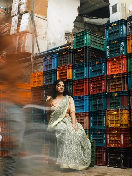 An editorial shoot set in a bustling market. I created a look that feels both contemporary and grounded, with natural curls and makeup that enhances the model's features against the vibrant, textured background.