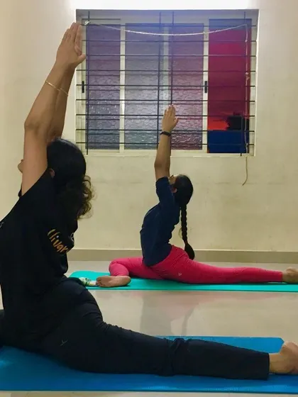 Students practicing Ekapadasana (One-Legged Pigeon Pose) in unison. This pose is a fantastic hip opener and helps release stored stress and emotion.
