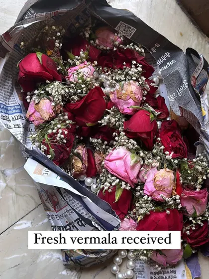 The journey begins. A fresh varmala, received from a client, wrapped in newspaper and ready to be sorted and dried.