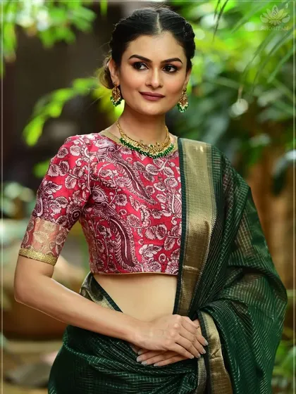 A delicate green beaded necklace is paired with a red printed blouse. The contrast in colors creates a vibrant look, perfect for festive daytime events.