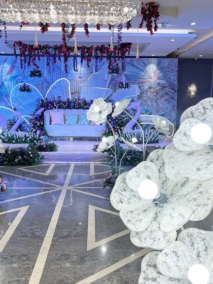 The full view of our 'Illuminated Garden' stage, with glowing floral props lining the aisle, creating a magical pathway.