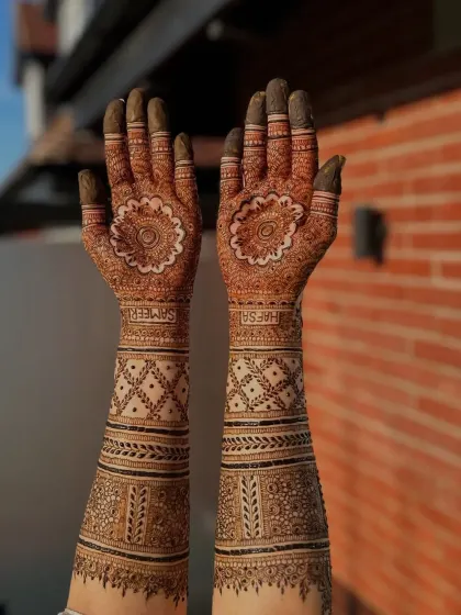This full arm design for bride Hafsa features her and her partner's names hidden within the pattern. It's a special way to personalize your bridal henna.