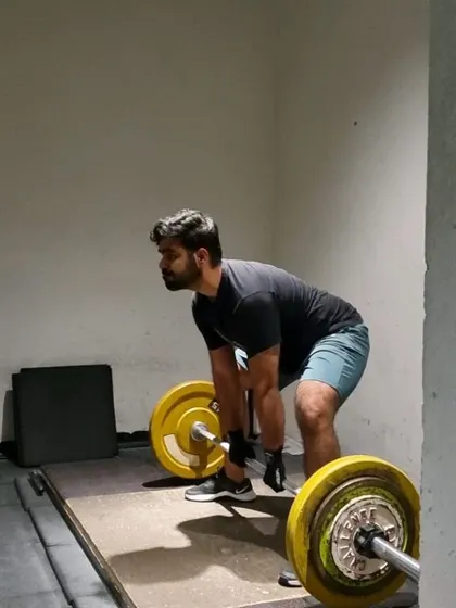 A client executing a deadlift with good form, a testament to consistent practice and coaching.