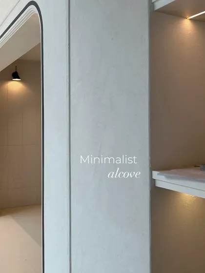 A detail of a minimalist alcove with integrated shelving and lighting. Even in the early stages, the clean lines and soft curves that characterize the project are evident.