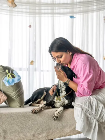 A dog mom gets a sweet kiss from her pet during our Mother's Day studio shoot. These are the moments that make the best memories.