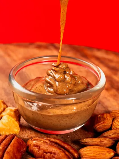A shot capturing a thick stream of chocolate hazelnut spread being poured. The motion and texture of the cascading chocolate are the heroes of this image.
